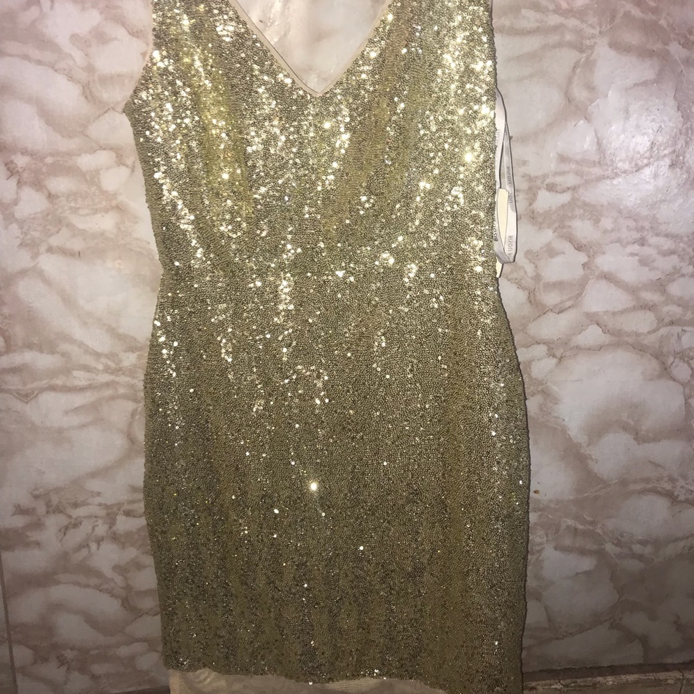 A gold tight dress . It’s never worn,